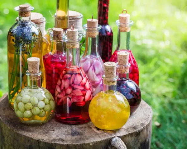 Fruchtige Liköre in Flaschen, bereit zum schnaps selber machen. Mit Beeren, Kräutern und Früchten gefüllt.