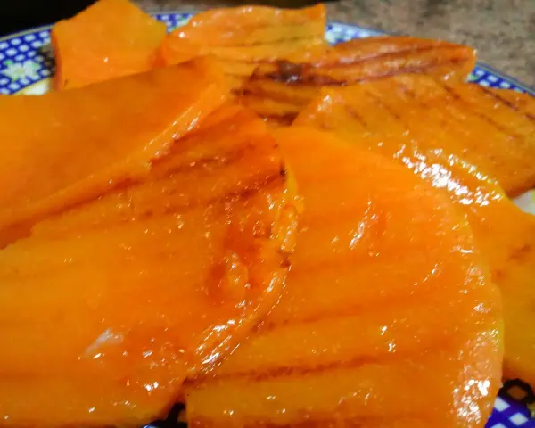 Rebanadas de calabaza a la plancha, doradas y jugosas, con marcas de parrilla.