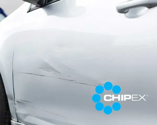 Scratches on a silver car door, with a CHIPEX logo. Can you buff out scratches like these?