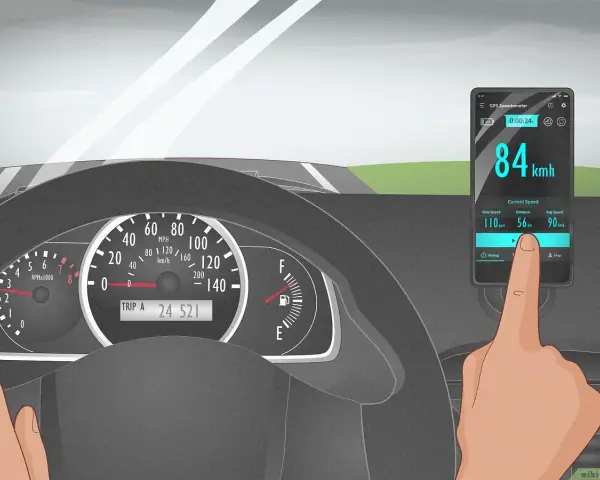 A finger touches a phone displaying a GPS speedometer showing 84 km/h, as the car's own speedometer is not working.