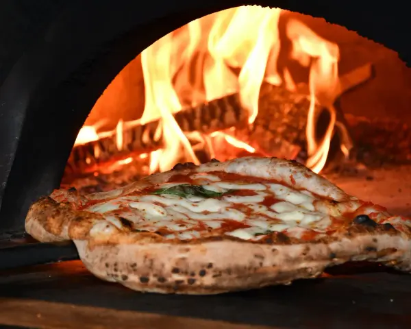 Skąd pochodzi pizza? Od starożytnych placków do globalnego fenomenu.