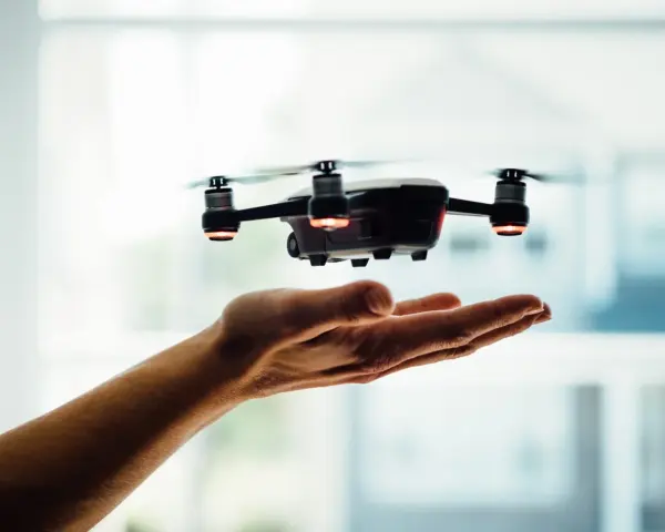 A drone hovers over an open hand, a visual metaphor for understanding Pennsylvania drone laws before takeoff.