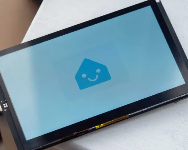 A screen displays the Home Assistant logo, ready for ESPHome Zigbee integration.
