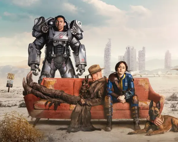 Personajes de Fallout 4 en un sofá desértico. Un soldado en armadura, un hombre con sombrero y una mujer con uniforme azul, junto a un perro. El amor en el páramo, un posible fallout 4 romance.