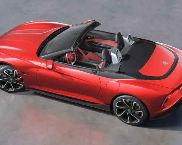 Czerwony MG Roadster z otwartym dachem, sportowe wnętrze, nowoczesne felgi i aerodynamiczne linie.