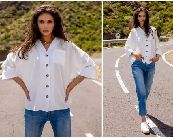 Modelka prezentuje, jak nosić koszulę damską do spodni. Biała, luźna koszula i jeansy tworzą stylowy, casualowy look.