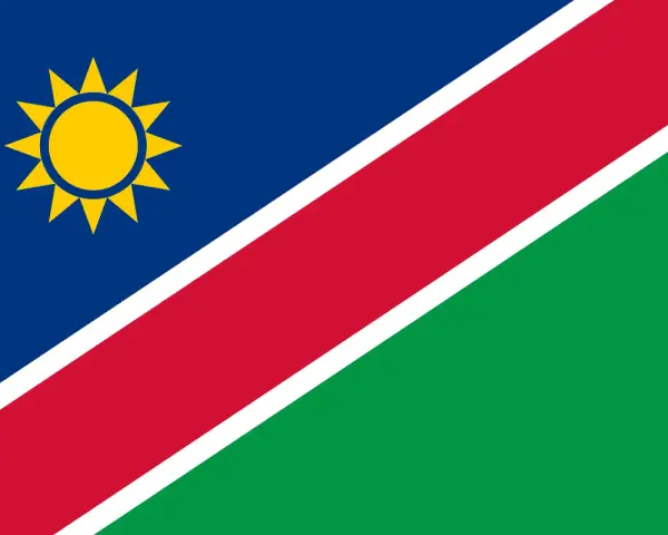 Flaga Namibii z żółtym słońcem. Marzysz o podróży? Sprawdź, czy potrzebna jest namibia wiza.