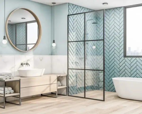 Salle de bain moderne avec baignoire îlot, douche vitrée et lavabo sur meuble en bois. Le mur derrière la douche est recouvert de **faïence** bleu sarcelle en chevrons.