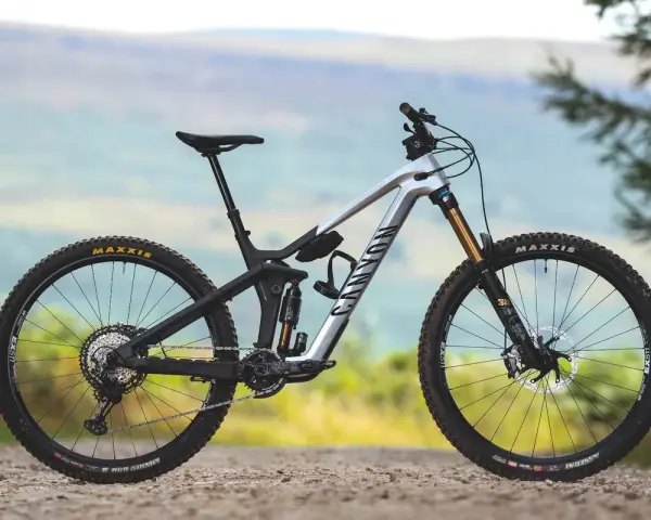 A silver Canyon enduro mountain bike with full suspension, ready to tackle any trail.