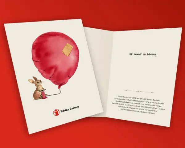 En kanin pumpar ett rött ballonghjärta med ett plåster. En barnvälsignelse present som stödjer Rädda Barnen.