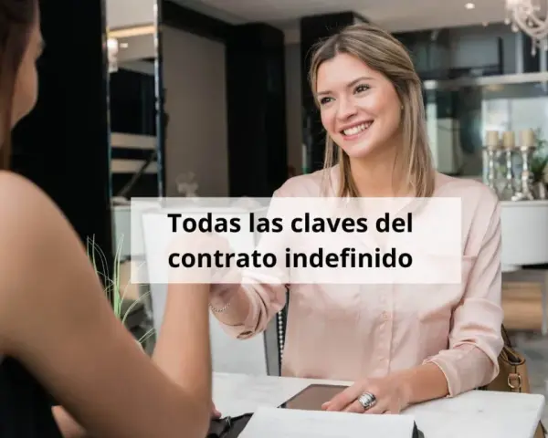Dos mujeres estrechan la mano, una sonríe. El texto dice "Todas las claves del contrato indefinido", sugiriendo un acuerdo laboral seguro.