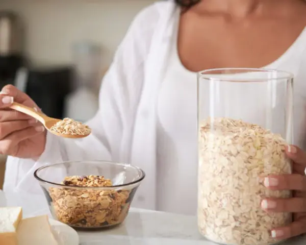 Mujer preparando un desayuno saludable. La avena es antiinflamatoria y perfecta para empezar el día con energía.