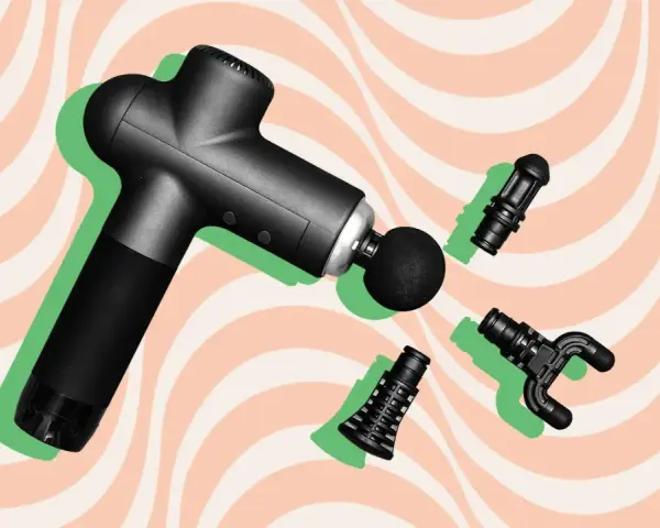 Black massage gun with interchangeable heads, hinting at the massage gun benefits study.