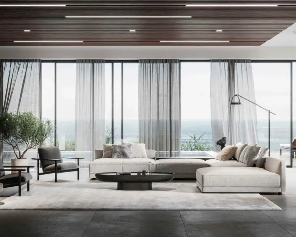 Soggiorno moderno con divano componibile, poltrone, tavolino e vista mare. L'arredamento evoca l'eleganza delle case stile americano, con linee pulite e materiali pregiati.