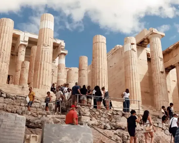 Tourists ascend the rocky path towards the Acropolis, a testament to how hard is the walk up to the Acropolis.