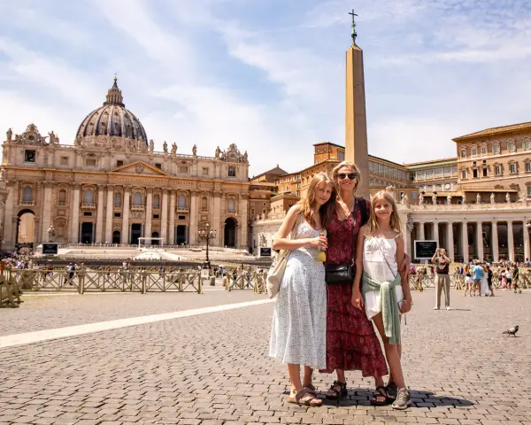 A family poses in St. Peter's Square, Rome, with St. Peter's Basilica in the background. A dream come true, seeing the Pope in Rome!