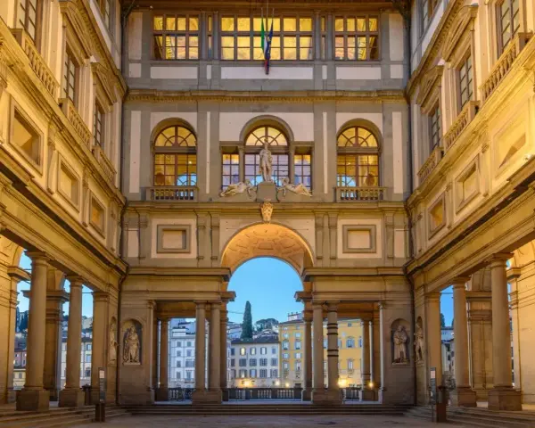 The Uffizi Gallery's courtyard at dusk, with its grand architecture and statues, offers a glimpse of Florence's artistic heritage, rivaling the Accademia.