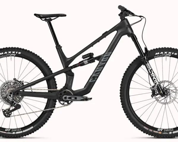 A black Canyon Spectral mountain bike, showcasing a mullet setup with a larger 29er front wheel and a smaller rear wheel, ready for any trail.