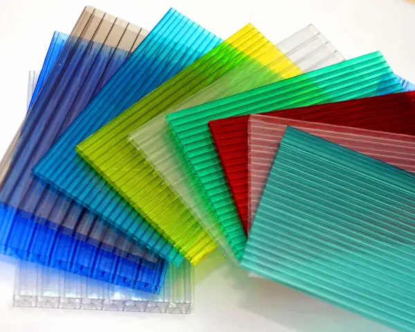 Sheets of colorful, ribbed polycarbonate, showcasing their versatility and potential for polycarbonate sustainability in various applications.