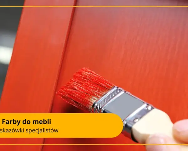 Pędzel z czerwonymi włoskami nakłada farby do malowania na drewnie na pomarańczowe meble.