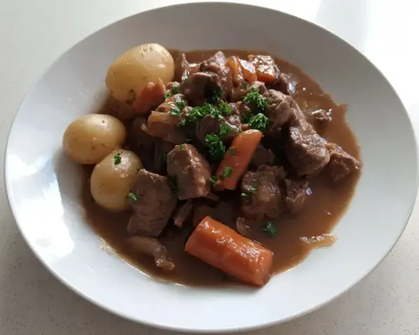 En härlig fransyska gryta med mört kött, mjuka potatisar och saftiga morötter, toppad med färsk persilja.