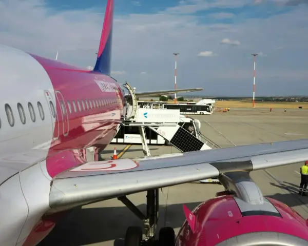 Samolot Wizz Air na płycie lotniska. Zastanawiasz się, co można zabrać do samolotu Wizzair? Sprawdź zasady przewoźnika przed podróżą.