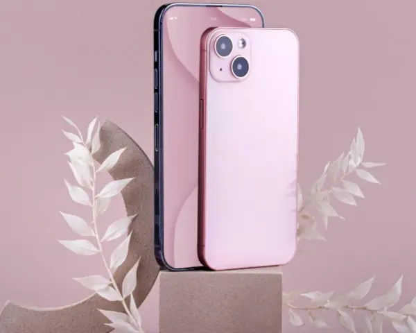 Dwa telefony, jeden ciemny, drugi różowy iPhone 11, stoją na kamiennych podstawkach, ozdobione delikatnymi, białymi gałązkami.
