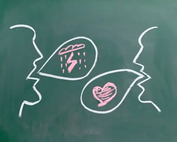 Chalk drawings of two profiles facing each other. One speaks of storms, the other of love, illustrating how do we love our enemies.