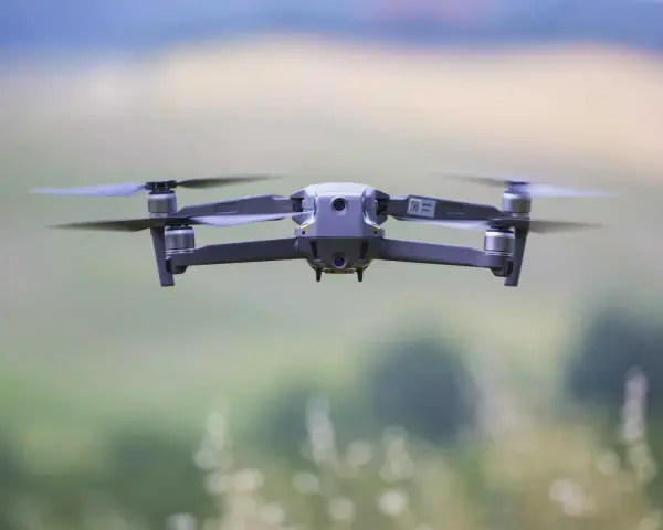 A drone hovers mid-air, its propellers blurred with motion. Planning to fly one in the Dominican Republic? Be sure to check the Dominican Republic drone laws first.