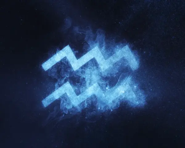 Błękitny symbol Wodnika, znaku zodiaku 6 lutego, lśni na tle nocnego nieba pełnego gwiazd.