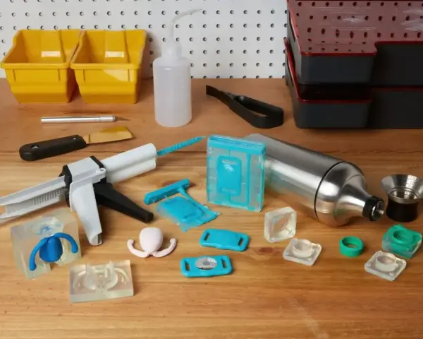 Tools for using resin in silicone molds are laid out, including a caulking gun, various silicone molds, and mixing containers.