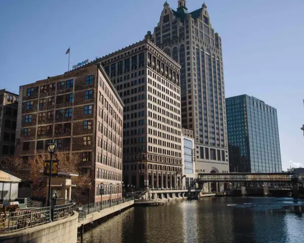 A scenic view of Milwaukee's riverfront buildings, perfect for a weekend getaway.