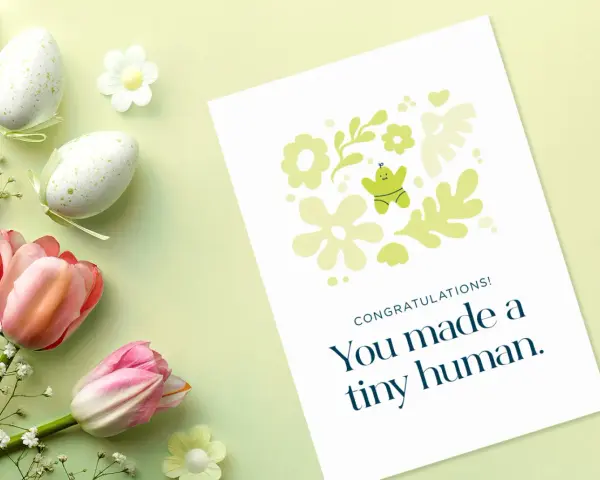 Gratulacje z okazji narodzin dziecka! Urocza kartka z motywem kwiatowym i małym ludzikiem.