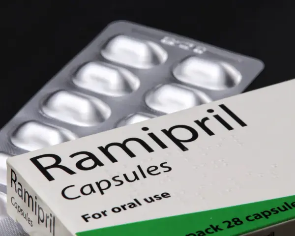 Ramipril kapsułki na nadciśnienie. Opakowanie leku i blister z tabletkami na czarnym tle.