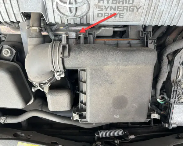 A red arrow points to a clip on the air intake system of a Toyota Hybrid Synergy Drive. This could be related to a p0102 code.
