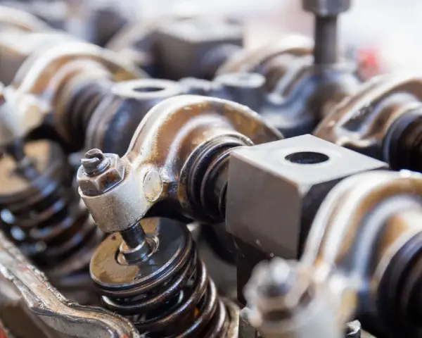 Close-up of engine valve train components, hinting at a camshaft sensor replacement.