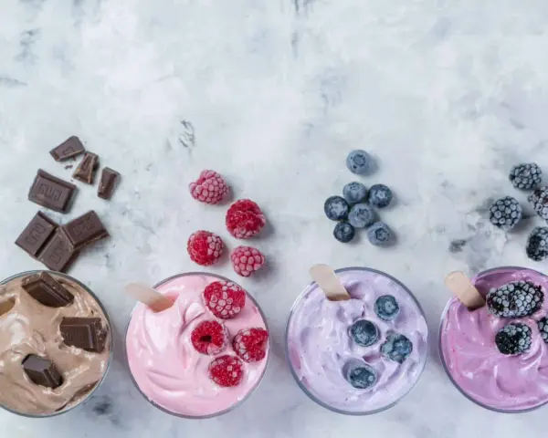Vier Gläser mit leckerem Nicecream: Schoko, Himbeer, Blaubeer und Brombeer. Perfekt für heiße Tage!