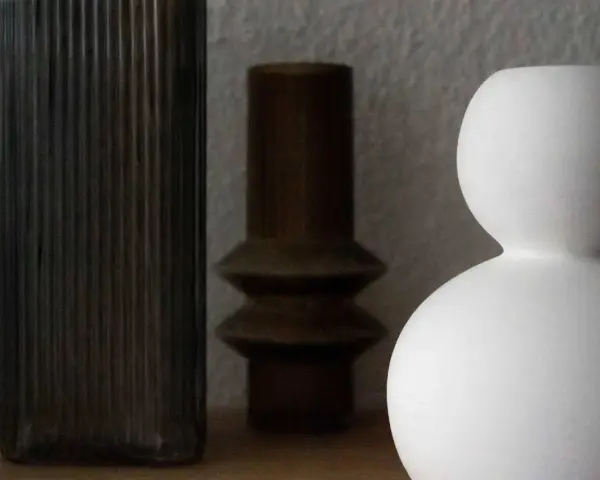 Drei Vasen: eine hohe, geriffelte dunkle, eine bauchige braune und eine weiße, die sich perfekt zum Vase dekorieren ohne Blumen eignen.