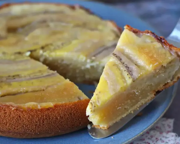Un delicioso bizcocho de plátano, con trozos de fruta dorados y una base esponjosa, listo para ser disfrutado.