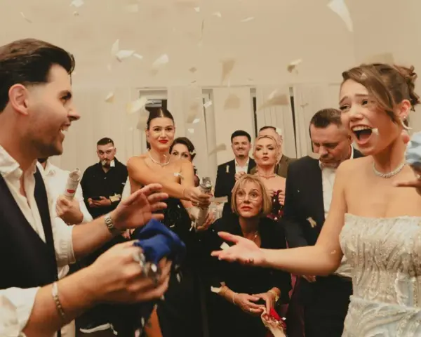 Wesele w pełni! Goście sypią konfetti, a młoda para cieszy się chwilą. Czy osoba towarzysząca daje prezent na wesele?