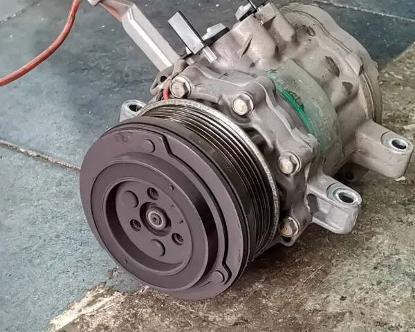 A car's AC compressor, a key component for cool air. Considering the ac compressor replacement cost? This part is vital for your comfort.