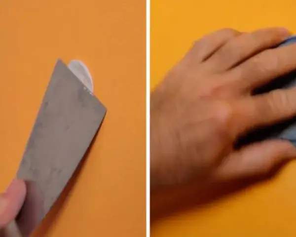 Herramienta para quitar tacos de la pared y mano lijando.