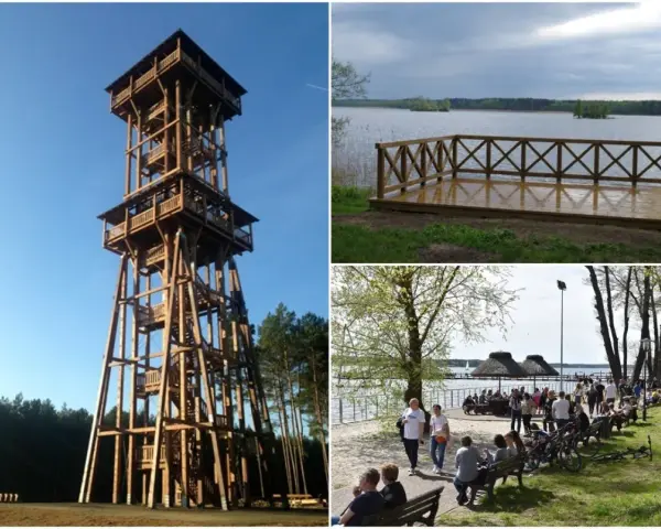 Wysoka, drewniana wieża widokowa Joanna góruje nad lasem. Obok jezioro z pomostem i plaża z ludźmi.