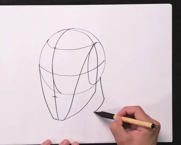 Un boceto de cabeza con líneas guía, parte de una lección de retratos fáciles.