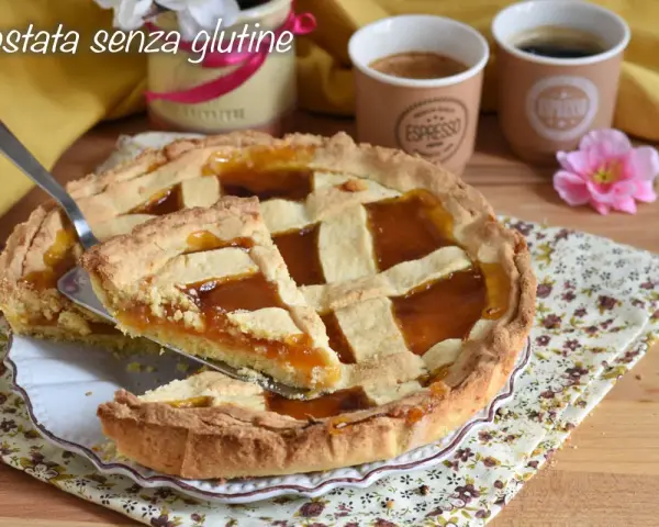 Una deliziosa crostata senza glutine con marmellata d'arancia, pronta per essere gustata con un caffè.