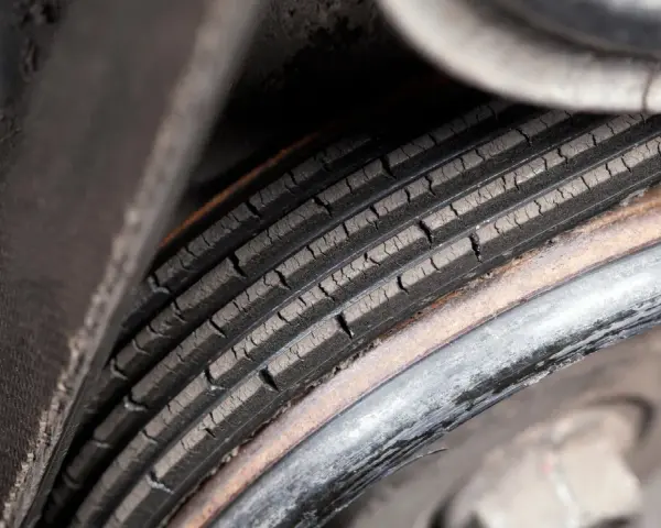 Cracked serpentine belt, a common cause of belt failure, shows signs of wear and tear.