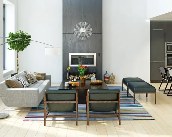 Nowoczesne wnętrza: szara sofa, kominek, designerskie krzesła i kuchnia. Różnorodne style wnętrz w jednym, przestronnym salonie.