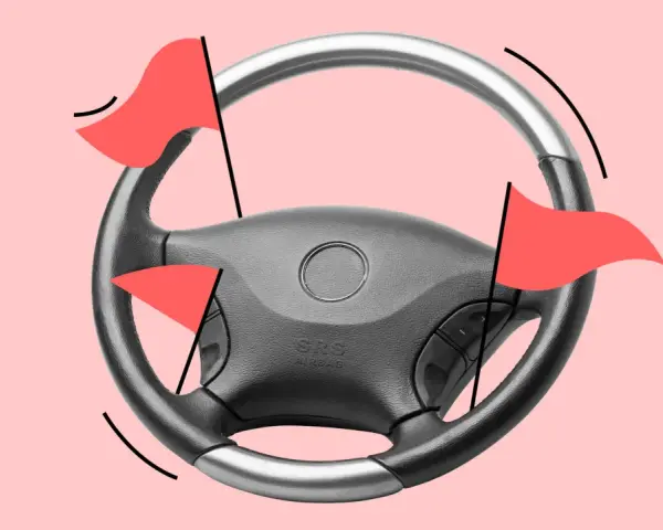 Lenkrad mit roten Flaggen, die auf einen hohen Kilometerstand des Autos hinweisen.