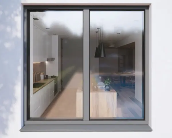 Vue d'une cuisine moderne et d'une salle à manger à travers un ouvrant fenêtre.