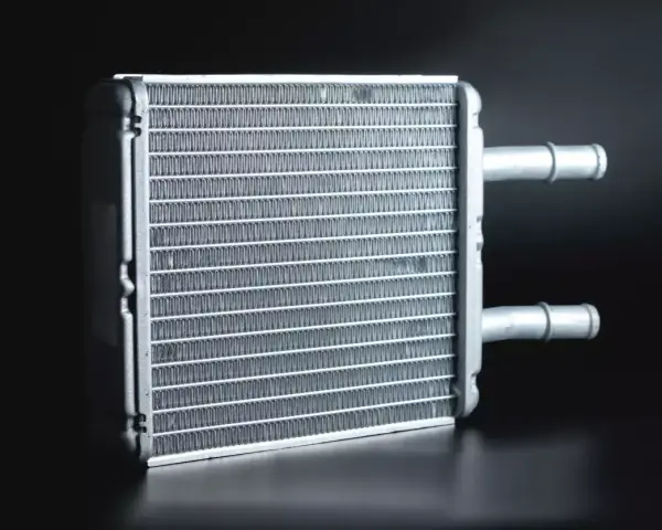 A new heater core, essential for a heater core replacement, sits ready for installation. Its fins are clean and ready to warm your car.